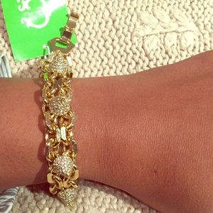 Gold chain link and rhinestone bracelet.